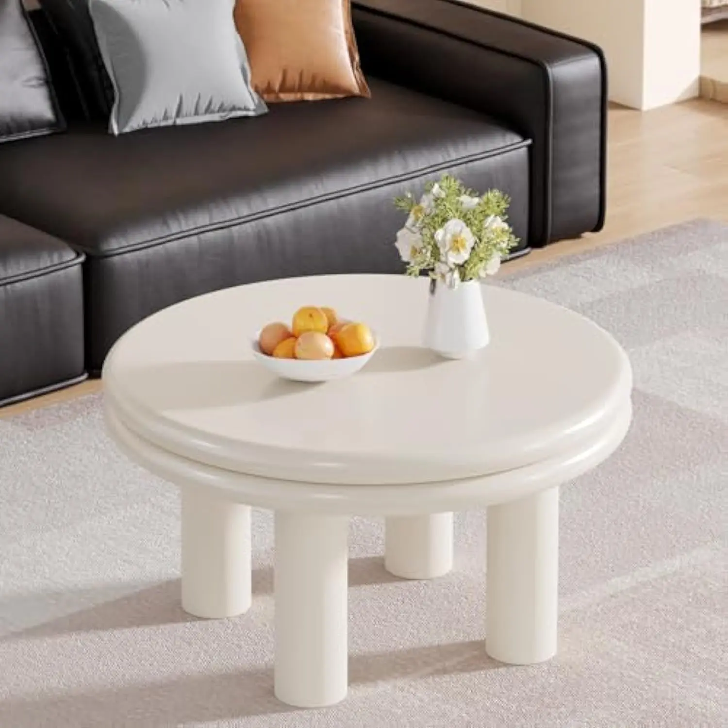 Round white Scandinavian-style coffee table with sleek tapered legs for modern living spaces